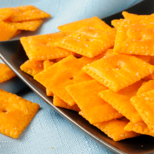 Sourdough cheese crackers, discard recipe, baked and lightly salted, served in a black plate