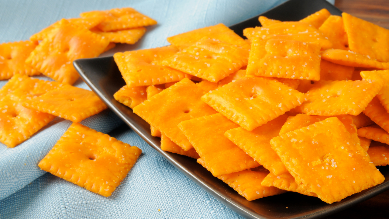 Sourdough cheese crackers, discard recipe, baked and lightly salted, served in a black plate